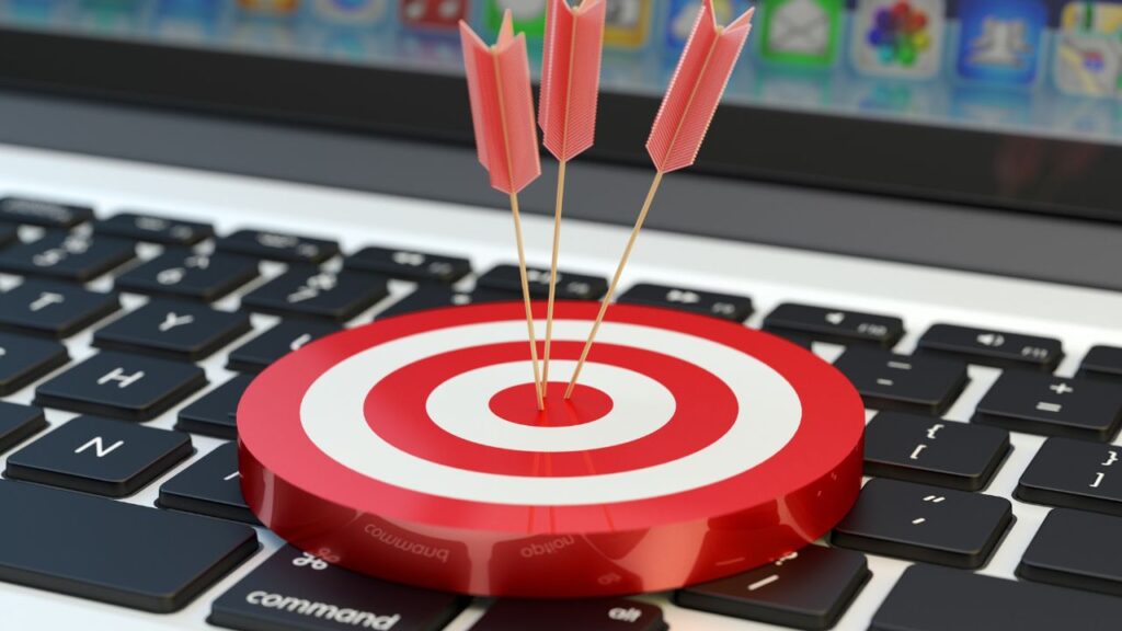 Obrazek przedstawia tarczę i trzy rzutki w niej