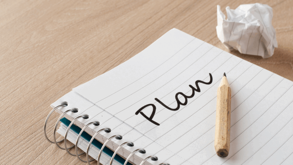 Obrazek przedstawia notatnik z napisem plan